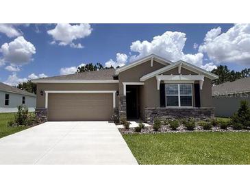 Charming single-story home featuring a two-car garage and beautiful stone accents at 9291 Sw 60Th Court Rd, Ocala, FL 34476
