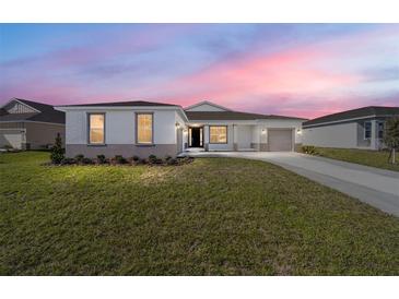 One-story home with two-car garage, landscaping, and driveway at 7781 Sw 59Th Ln, Ocala, FL 34474