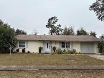 Ranch style home with a well-maintained lawn and attached garage at 14788 Sw 39Th Cir, Ocala, FL 34473