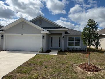 Charming single-story home with a well-manicured front yard and a two-car garage at 2138 Nw 23Rd Loop, Ocala, FL 34475
