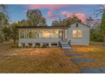 Charming white house with a spacious front porch and stone pathway at 217 Nw 14Th St, Ocala, FL 34475