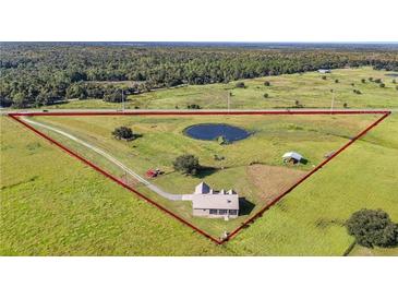 House situated on a large lot with pond at 4027 N C 470, Lake Panasoffkee, FL 33538