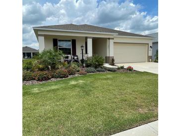 Charming single-story home features a manicured lawn and beautiful landscaping at 7682 Sw 89Th Ct, Ocala, FL 34481