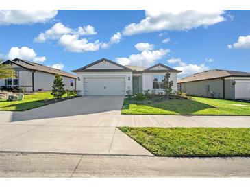 Two-car garage and neutral color scheme in a residential neighborhood at 8456 Sw 52Nd Lane Rd, Ocala, FL 34481