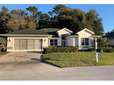 Single-story house with a two-car garage and well-maintained landscaping at 11557 Sw 75Th Cir, Ocala, FL 34476