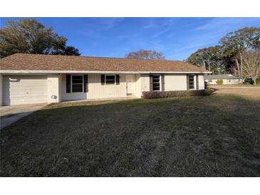 Ranch-style home with brown roof and mature landscaping at 2191 Ne 40Th St, Ocala, FL 34482