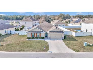 Attractive single-story house with a landscaped yard, driveway and a fenced-in pool at 2936 Ne 43Rd Rd, Ocala, FL 34470