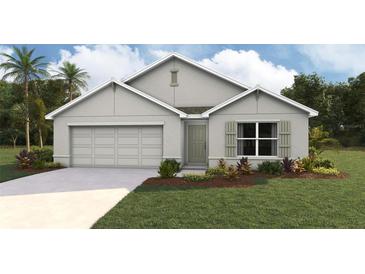 One-story home with gray exterior, two-car garage, and landscaped lawn at 7235 Se 113Th Ln, Belleview, FL 34420