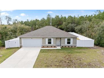 Newly built home with a fenced yard and a concrete driveway at 16050 Sw 35Th Court Rd, Ocala, FL 34473