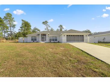 Newly constructed home with a spacious yard and attached garage at 16689 Sw 22Nd Terrace Rd, Ocala, FL 34473