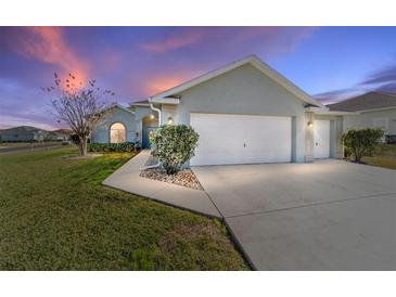 Charming single-story home with a two-car garage and manicured lawn at 2111 Nw 58Th Ct, Ocala, FL 34482