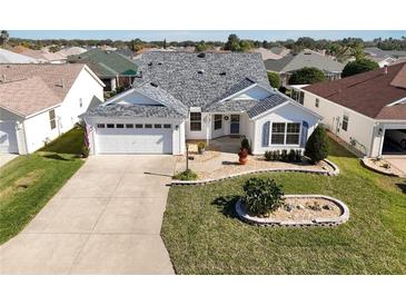 Attractive single-story home with landscaped yard and two-car garage at 3165 Hudson Ct, The Villages, FL 32162