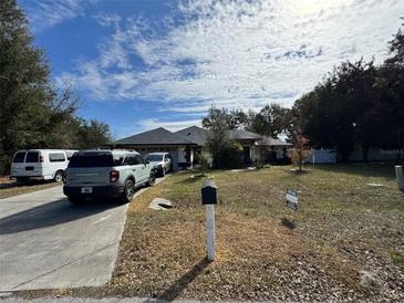 One-story home with gray roof and driveway, for sale at 5491 Sw 100Th Loop, Ocala, FL 34476