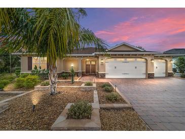 Attractive single-story home with three-car garage and landscaped yard at 9010 Sw 89Th Loop, Ocala, FL 34481