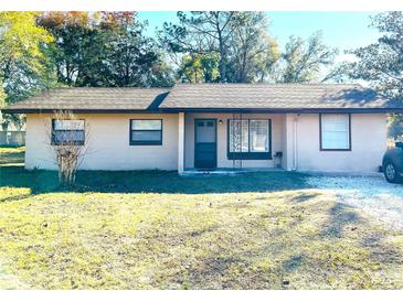 Inviting single-story home with a well-maintained lawn at 15000 Sw 27Th Ln, Ocala, FL 34481