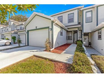 Two-story townhome with attached garage and landscaped walkway at 231 Ne 28Th Ave # 204, Ocala, FL 34470