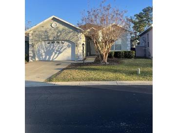 Single-story home with attached garage and well-manicured lawn at 3003 Sw 41St Pl, Ocala, FL 34474