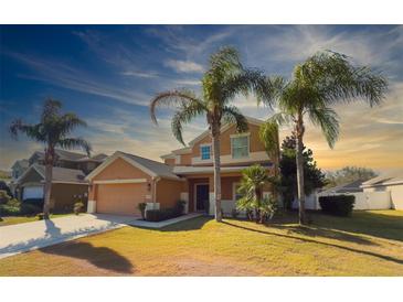 Two-story house with palm trees, attached garage, and a well-manicured lawn at 4098 Sw 51 St, Ocala, FL 34474