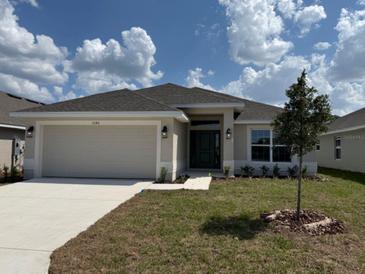 Charming single-story home with a well-manicured lawn and attached two-car garage at 2146 Nw 23Rd Loop, Ocala, FL 34475