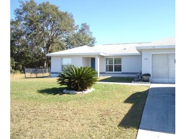 House exterior with driveway, landscaping and a carport at 221 Locust Ln, Ocala, FL 34472