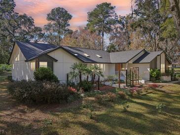 Charming single-story home showcasing a well-manicured front yard and a beautiful roofline at 4400 Sw 20Th Ave, Ocala, FL 34471