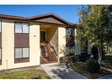 Front view of condo building with stairs and landscaping at 512 Bahia Cir # 512B, Ocala, FL 34472