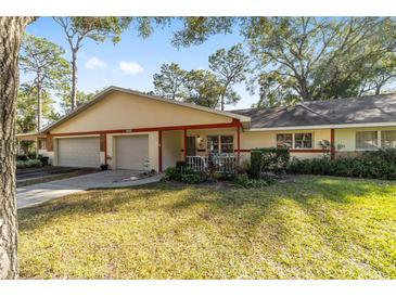 Exterior view of a house with a two-car garage and a spacious yard at 8580 Sw 97Th Lane Rd # B, Ocala, FL 34481