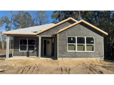 Newly constructed home with gray siding and a covered porch at 2881 Se 140Th Pl, Summerfield, FL 34491