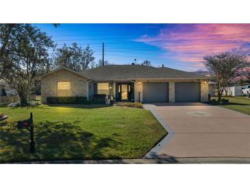 Charming one-story home with stone accents and a two-car garage at 3660 Se 54Th Ave, Ocala, FL 34480