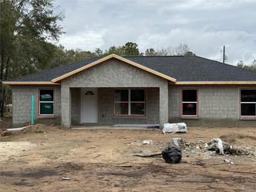 Newly constructed one-story home with a dark gray roof and white front door at 5411 Nw 7Th Pl, Ocala, FL 34482