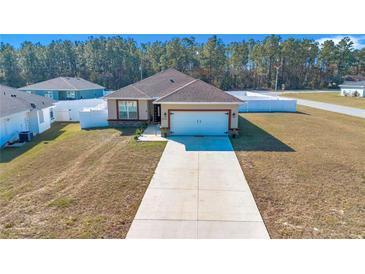 Single-story home with attached garage and driveway at 7646 Sw 129Th Pl, Ocala, FL 34473