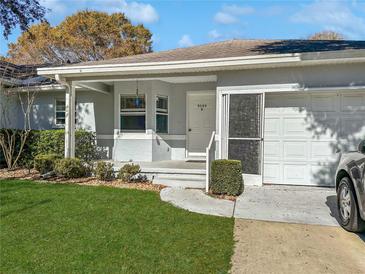 Single-story home with attached garage and well-manicured lawn at 9395 Sw 97Th Ln # B, Ocala, FL 34481