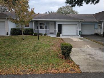 Front view of a single-story house with a garage and driveway at 9395 Sw 97Th Ln # B, Ocala, FL 34481