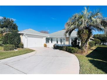 House exterior with driveway and landscaping at 11441 Sw 68Th Ct, Ocala, FL 34476