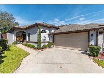 One story home with attached garage and manicured lawn at 2011 Se Twin Bridge Cir, Ocala, FL 34471