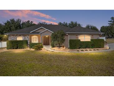 Beautiful home with stone accents and landscaping at 3819 Se 38Th Loop, Ocala, FL 34480