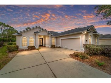 Single-story home with attached garage and manicured landscaping at 4911 Sw 63Rd Loop, Ocala, FL 34474