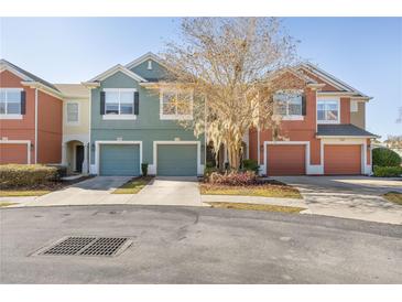 Three-unit townhome building with attached garages and landscaping at 4947 Sw 45Th Cir, Ocala, FL 34474