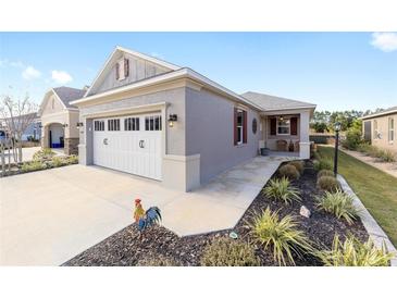 Single-story home with a two-car garage and nicely landscaped front yard at 7995 Sw 89Th Cir, Ocala, FL 34481