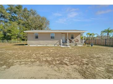 Tan single-story house with front porch and yard at 17175 Ne Jacksonville Rd, Citra, FL 32113