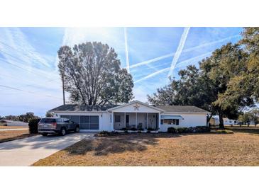 White single story home with carport and spacious yard at 6180 Sw 110Th St, Ocala, FL 34476