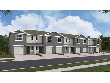 Modern townhome community with attached garages and landscaping at 8380 Gower Trl, Wildwood, FL 34785