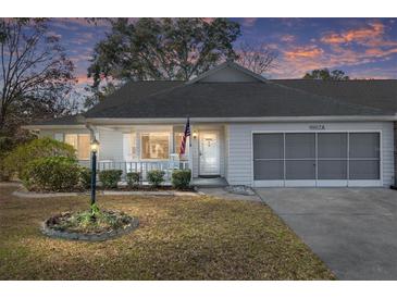 Inviting exterior of a single-story home with a porch and well-maintained landscaping at 9802 Sw 88Th Ter # A, Ocala, FL 34481