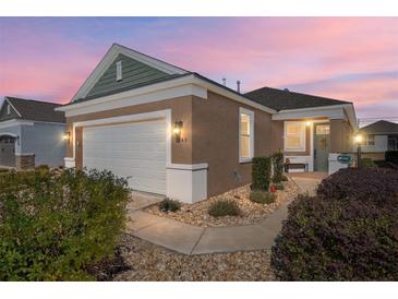 Attractive one-story home with a two-car garage and landscaped front yard at 9945 Sw 100Th Terrace Rd, Ocala, FL 34481