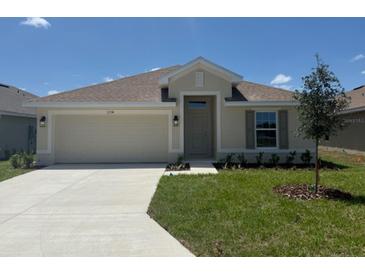 Charming one-story home with a well-manicured lawn and an attached two-car garage at 2154 Nw 23Rd Loop, Ocala, FL 34475
