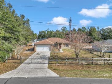 One-story home with attached garage and fenced yard at 3 Locust Trak, Ocala, FL 34472