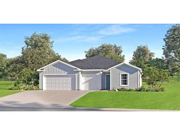 Newly constructed home with gray siding, two-car garage, and landscaped lawn at 6609 Sw 89Th Loop, Ocala, FL 34476