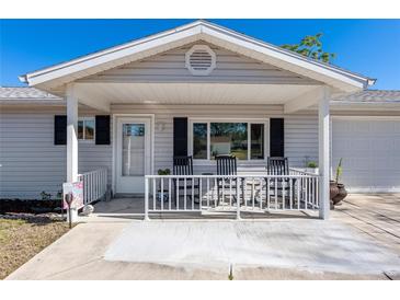 Inviting front porch with rocking chairs, perfect for relaxing at 11253 Sw 77Th Ct, Ocala, FL 34476