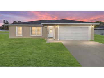 Newly constructed single-story home with a two-car garage and a well-manicured lawn at 200 Oak Lane Run, Ocala, FL 34472