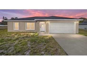 Charming single-story home with well-maintained lawn and attached two-car garage at 200 Oak Lane Run, Ocala, FL 34472